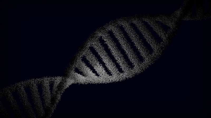 Artistic rendering of a DNA strand with particle effects against a dark background.