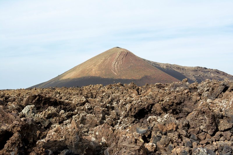 Scenic view of volcanic landscape with rocky terrain in Lanzarote, Spain.